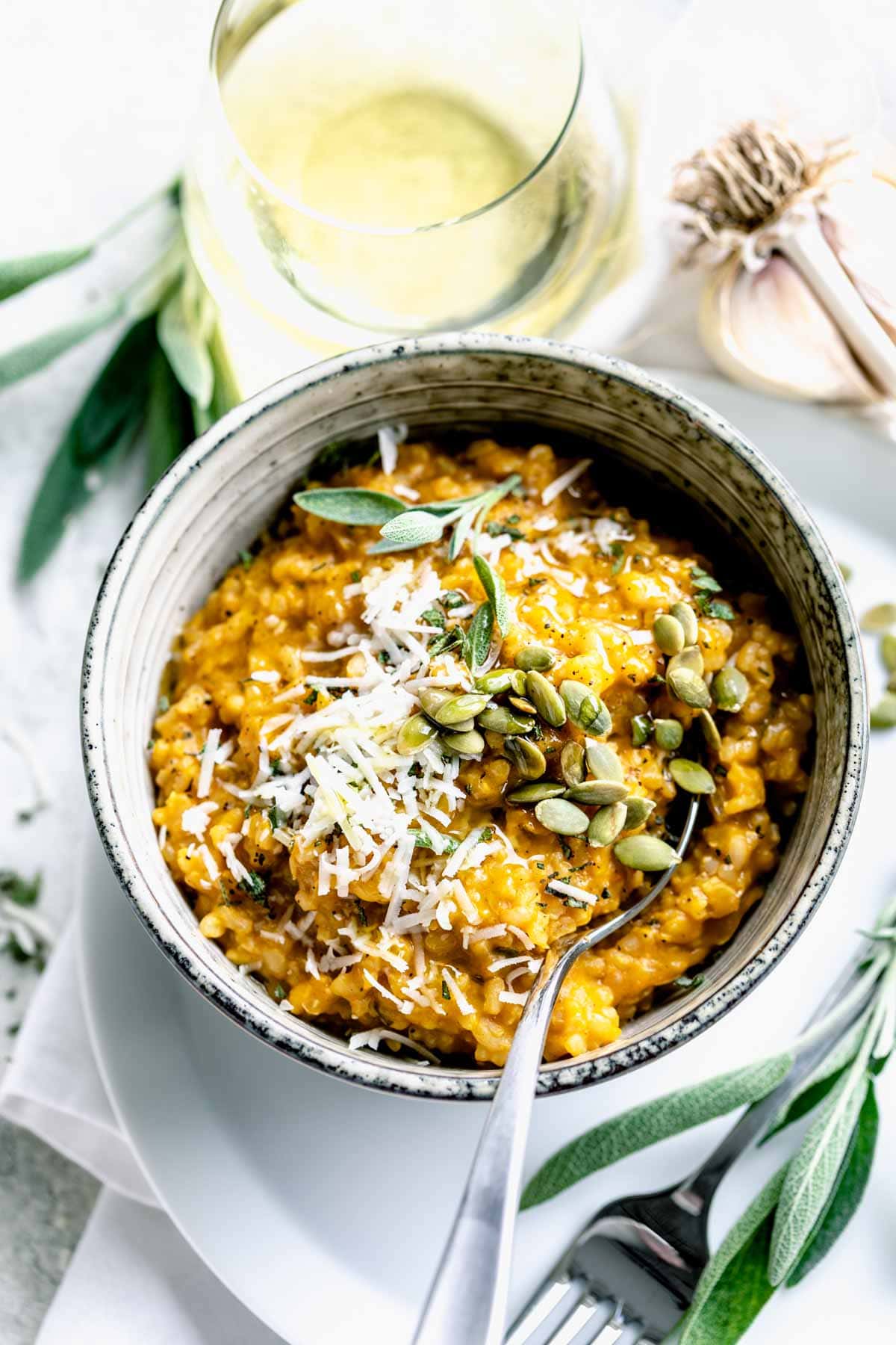 a bowl of pumpkin risotto with sage garnish