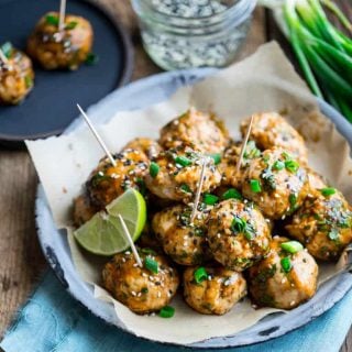 Hoisin Glazed Asian Turkey Meatballs on circular serving dish with toothpicks and a slice of lime