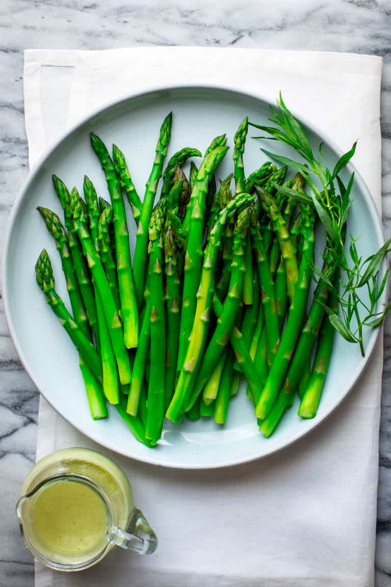 A chilled Asparagus Vinaigrette salad with dressing on the side