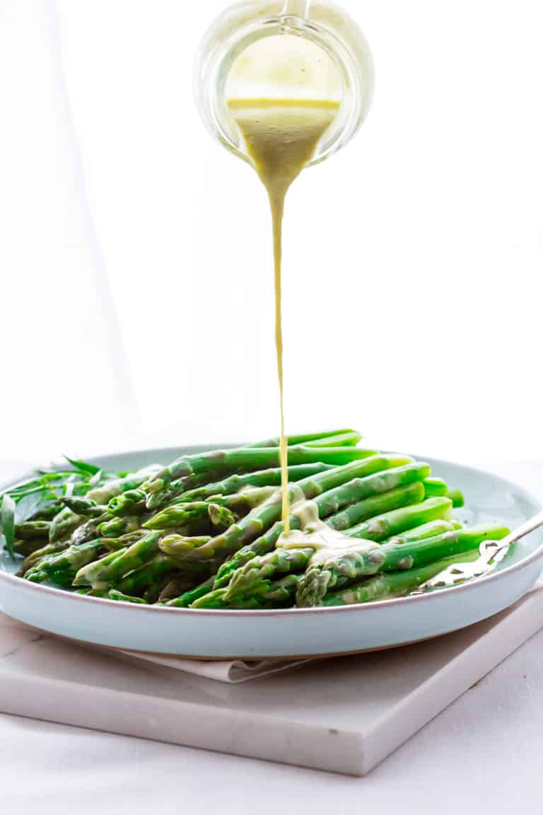 Asparagus with Vinaigrette being poured over top