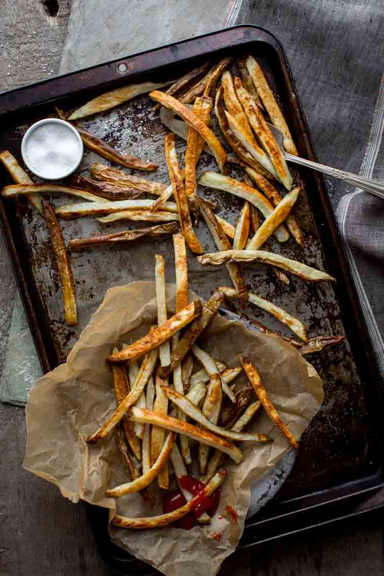 Skinny Oven Fries on baking tray with parchment paper