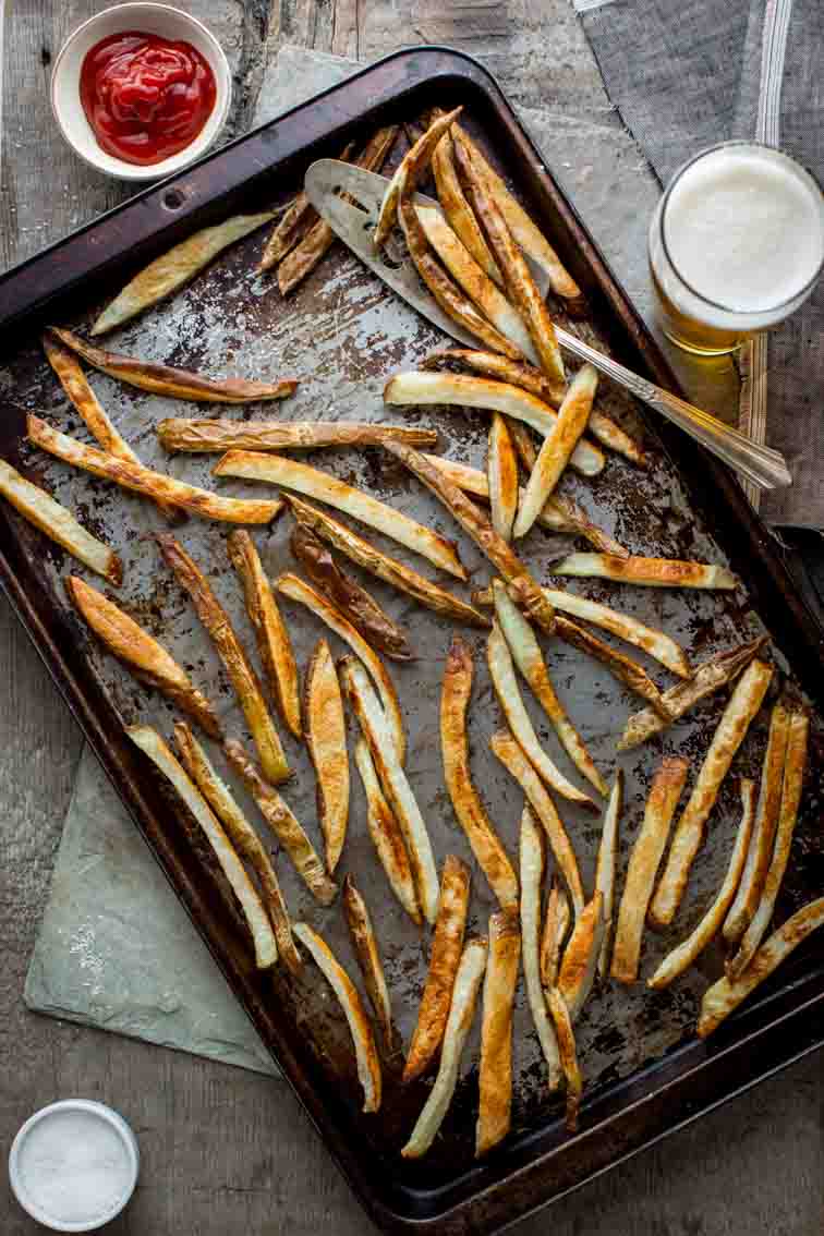 Skinny Oven Fries on baking tray next to ketchup