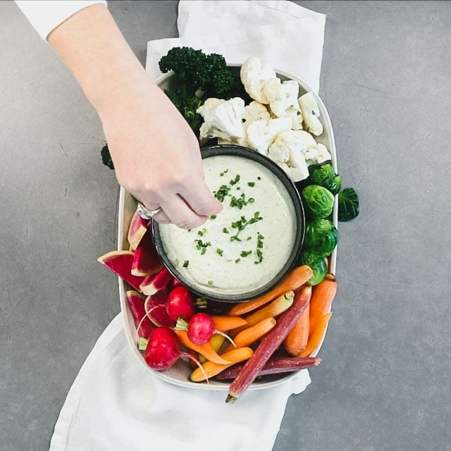 Transfer the dip to a bowl and sprinkle with herbs. Arrange the vegetables around the dip to serve.