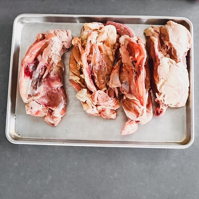 chicken carcasses on a baking sheet