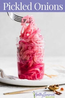 pickled red onions in a jar with text