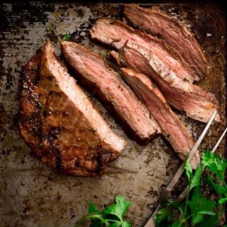 a close up of sliced flank steak cooked medium rare