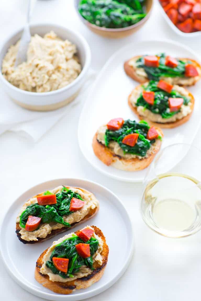 White Bean Crostini with a glass of white wine alongside