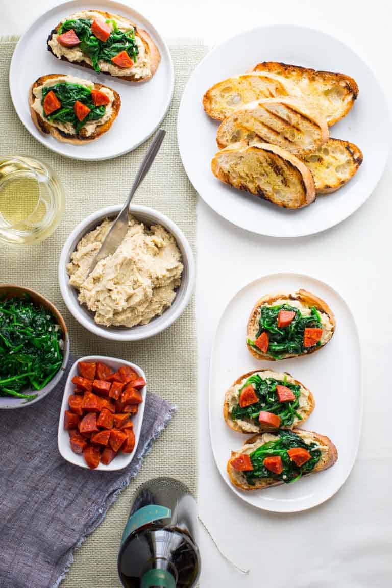 overhead shot of Bean Bruschetta with toast and white bean spread alongside