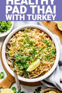 white bowl of pad thai noodles and fresh herbs from overhead