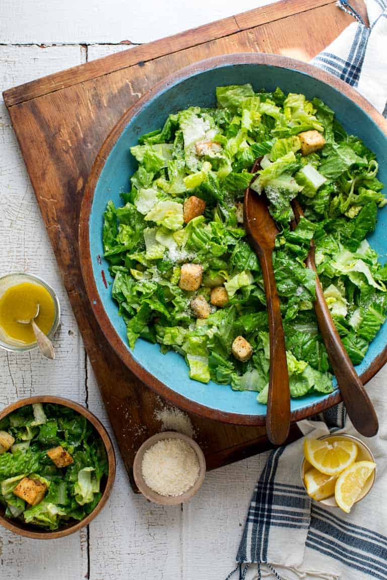 Egg-free caesar dressing alongside a bowl of Caesar salad