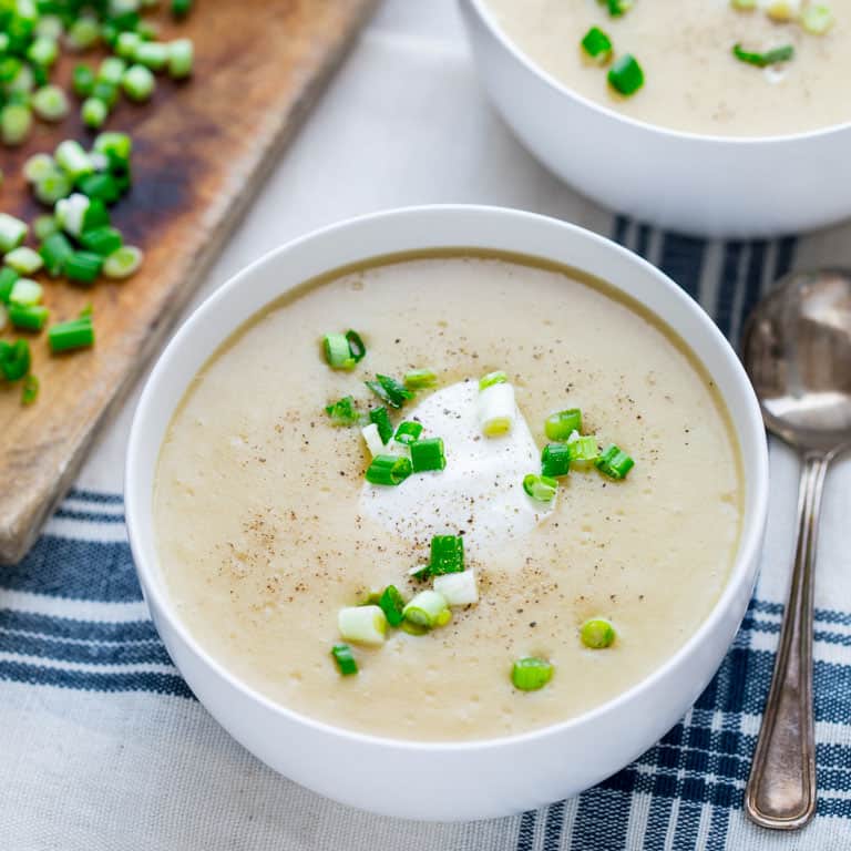 This Roasted Garlic Cheddar Soup will literally warm you up from the inside out! It is filled with yummy cheddar cheese and roasted garlic making it the perfect Winter comfort food and gluten free meal! | Healthy Seasonal Recipes | Katie Webster