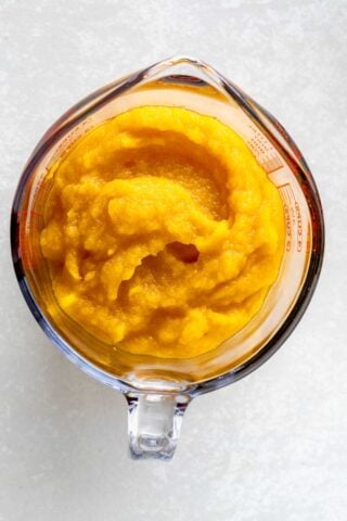 pumpkin puree in a measuring cup