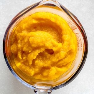 pumpkin puree in a measuring cup
