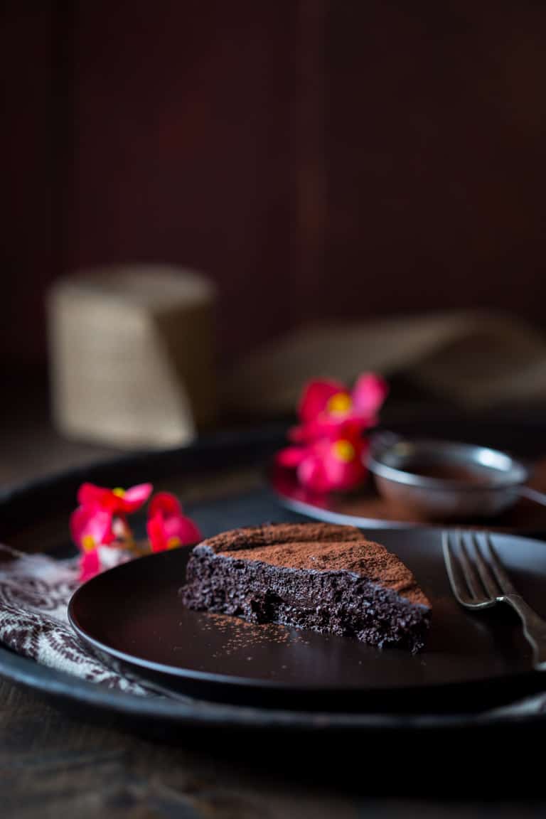 Flourless Chocolate Cake slice on a black plate