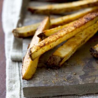 cajun oven fries on a slate board