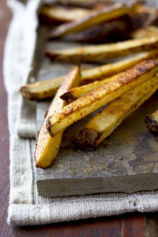 cajun oven fries on a slate board