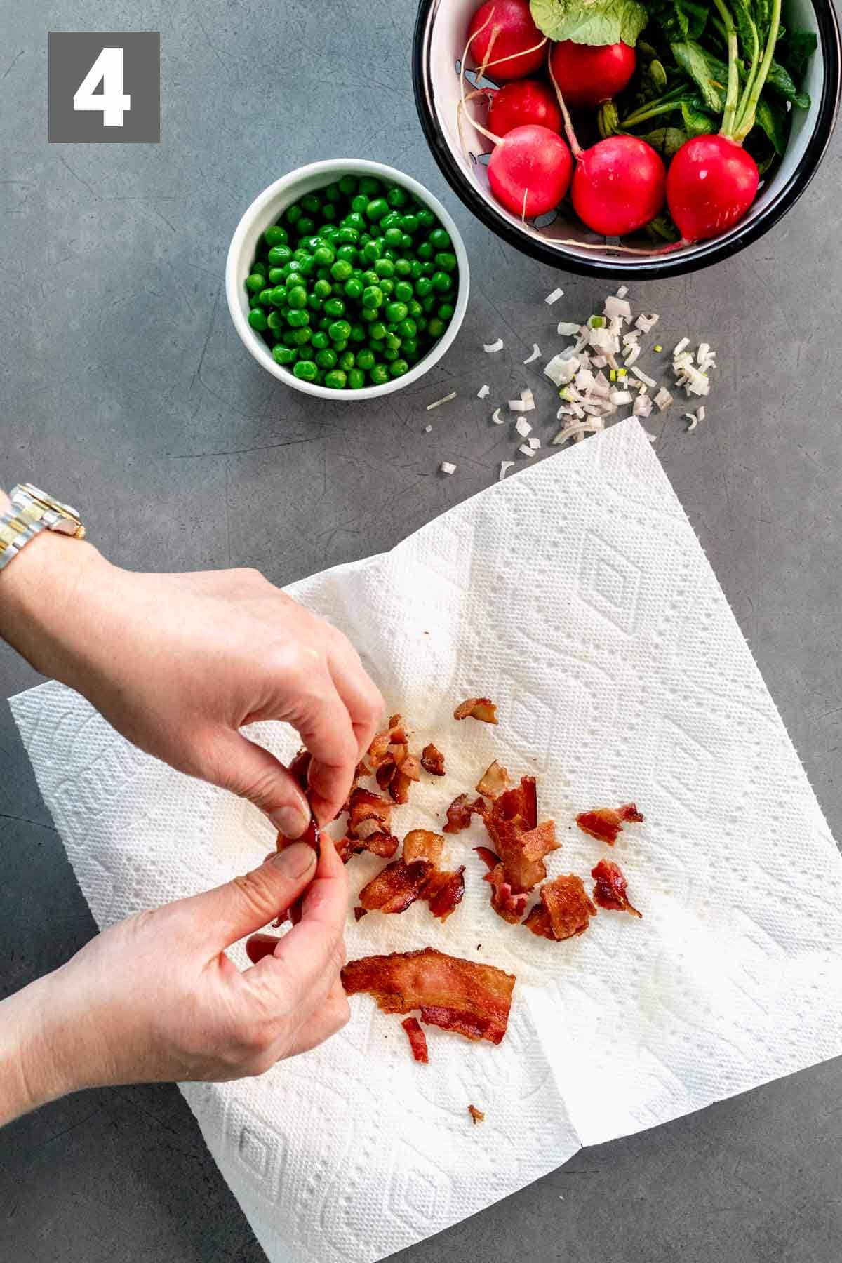 crumbling the bacon on a towel