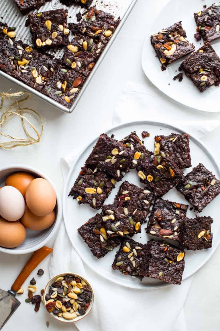 Fudgy Greek Yogurt Trail Mix Brownies on a serving plate alongside eggs