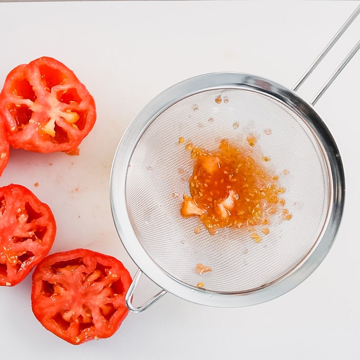 tomato seeds in a sieve