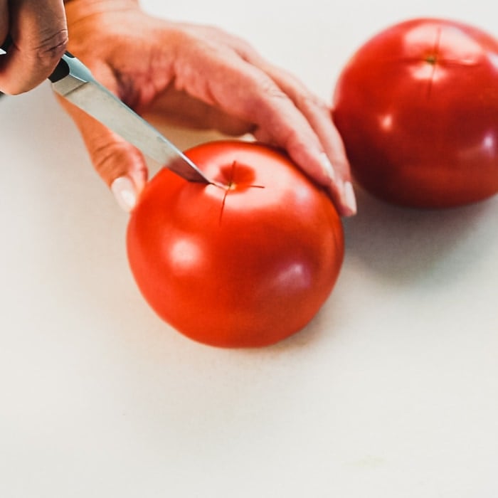Score an "x" mark at the bottom of each tomato