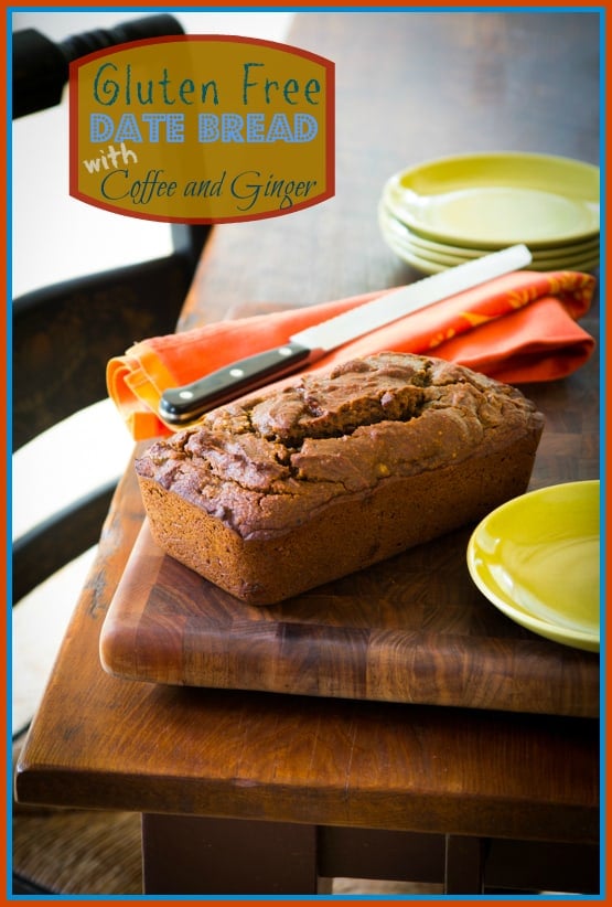 gluten free date bread with coffee and ginger on a wood cutting board next to a knife on a orange linen with green plates on a wooden table