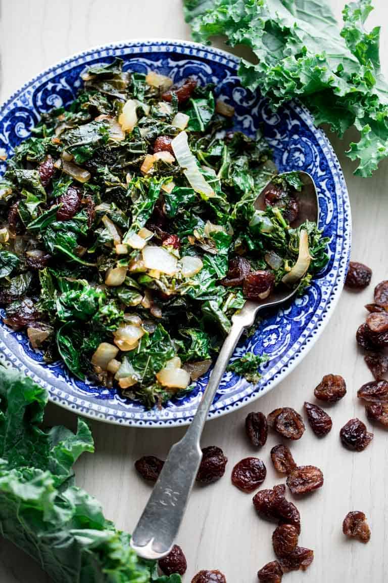 overhead view of blue bowl with balsamic sauteed kale