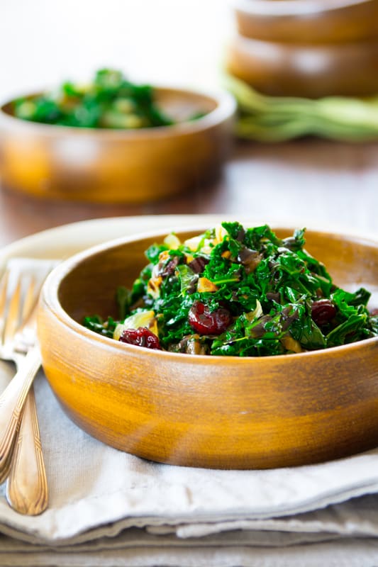 A bowl of food on a table, with Kale and Balsamic Vinegar