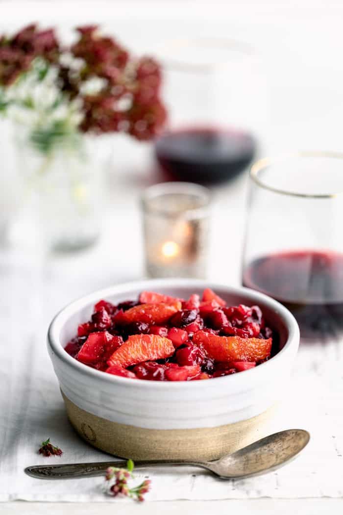 a side view of cranberry sauce in a white farmhouse pottery bowl