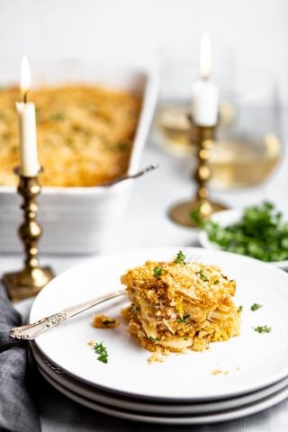 slice of parsnip gratin on layered circular white plates.