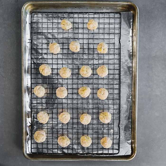 Line a sheet pan with foil and set a rack on top. Spray with cooking spray. Set the meatballs on a c