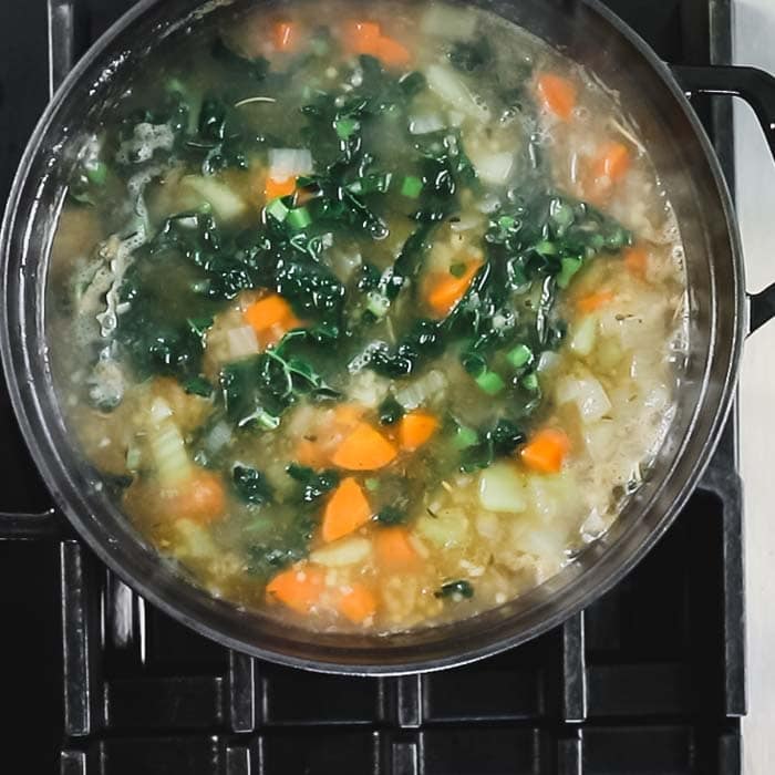 When timer goes off, add in chopped greens and continue cooking until the greens and pasta are tender.