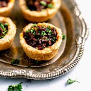 mini beef wellingtons on a silver platter