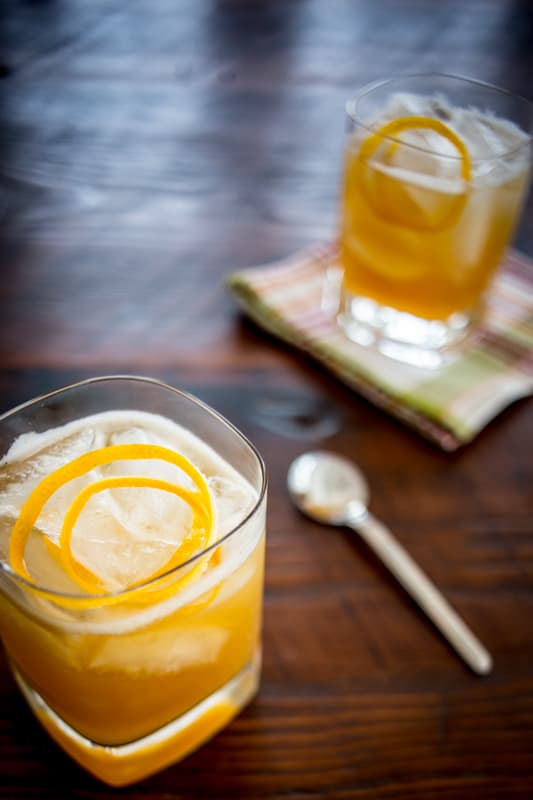 maple meyer lemon sour mix for whiskey sour cocktail in two cocktail glasses 