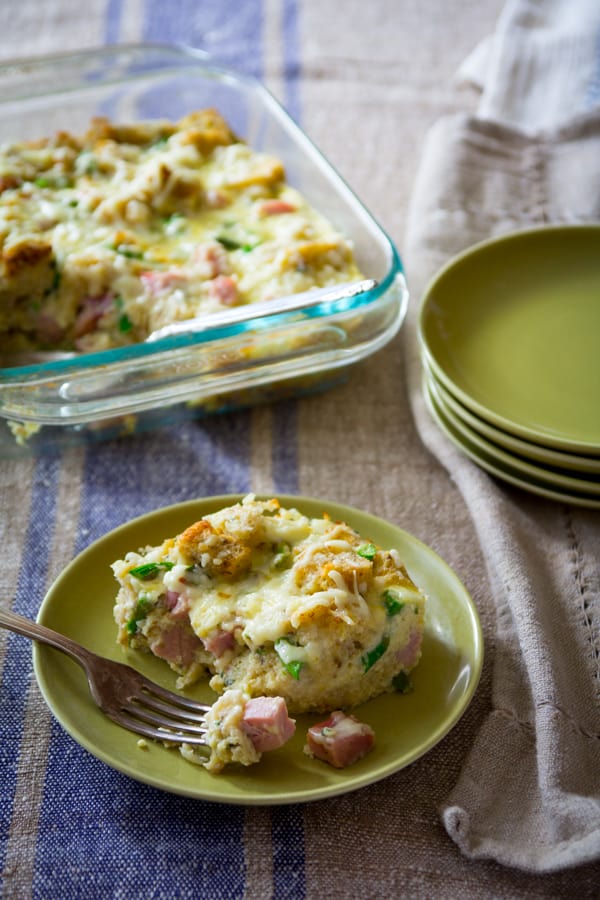 Easy Ham and Asparagus Bread Pudding on a serving plate with a fork