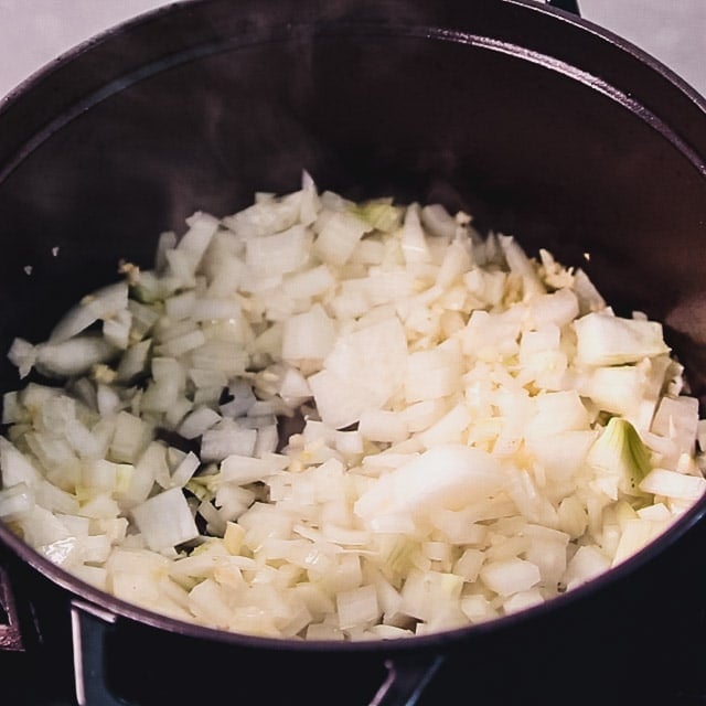 A dutch oven with onions in it