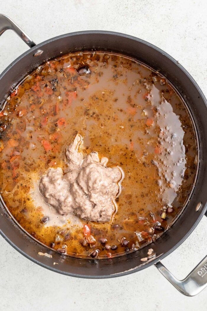 add the pureed beans into the soup to thicken it
