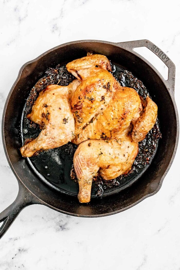 the roasted spatchcocked chicken in the skillet