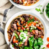 black bean soup with cilantro on top and greek yogurt with pico de gallo