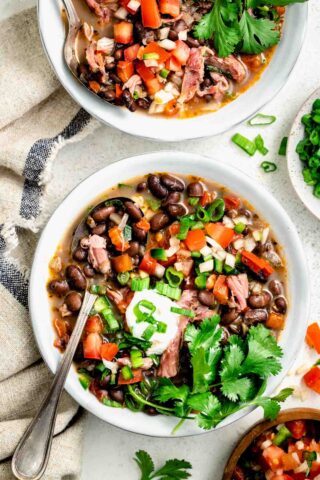 black bean soup with cilantro on top and greek yogurt with pico de gallo