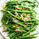 the salad on a platter from overhead on a gray and white plastic placemat