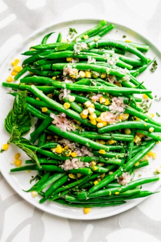 the salad on a platter from overhead on a gray and white plastic placemat