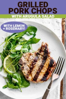 a plate with a pork chop and arugula salad