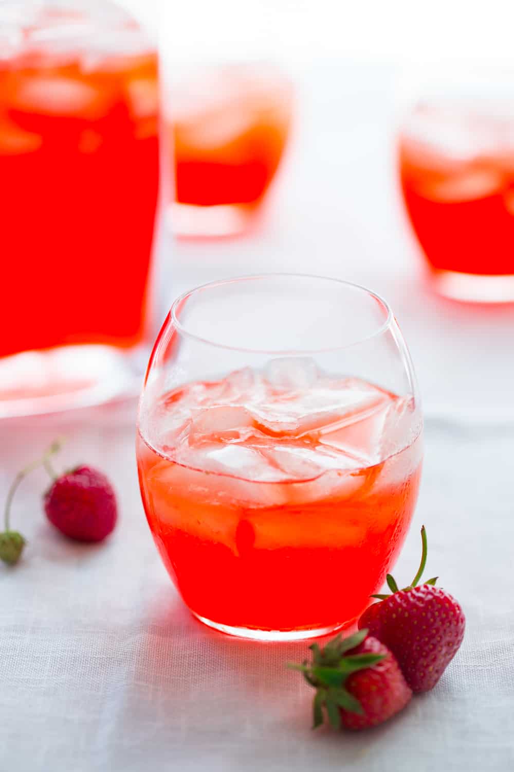 strawberry ginger pink lemonade cocktails in a pitcher and glasses