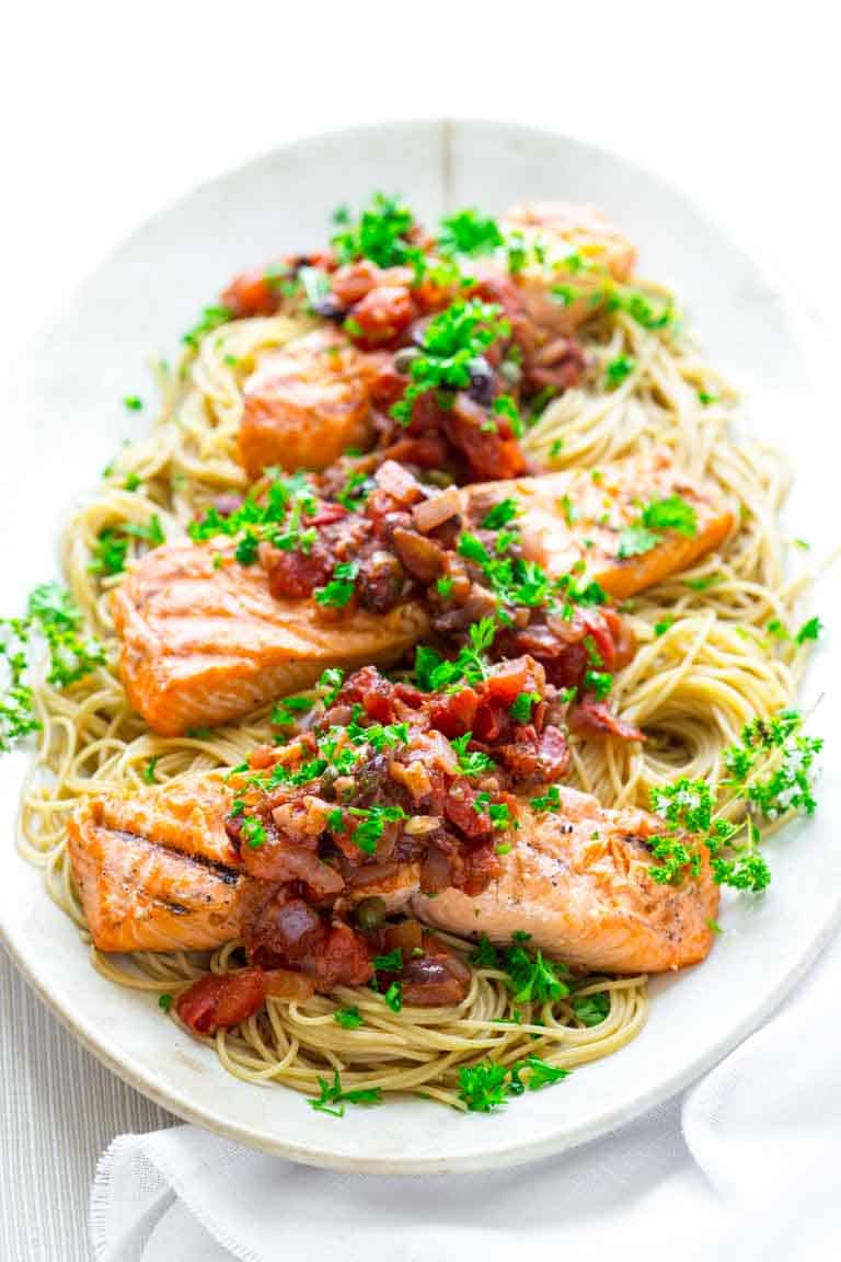 Healthy Grilled Salmon Puttanesca with Garlic tomato sauce with olives and capers. @healthyseasonal