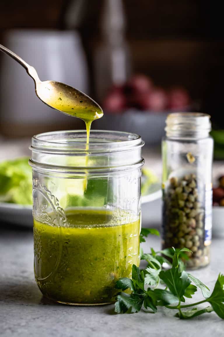 Caper Vinaigrette in a jar with a spoon