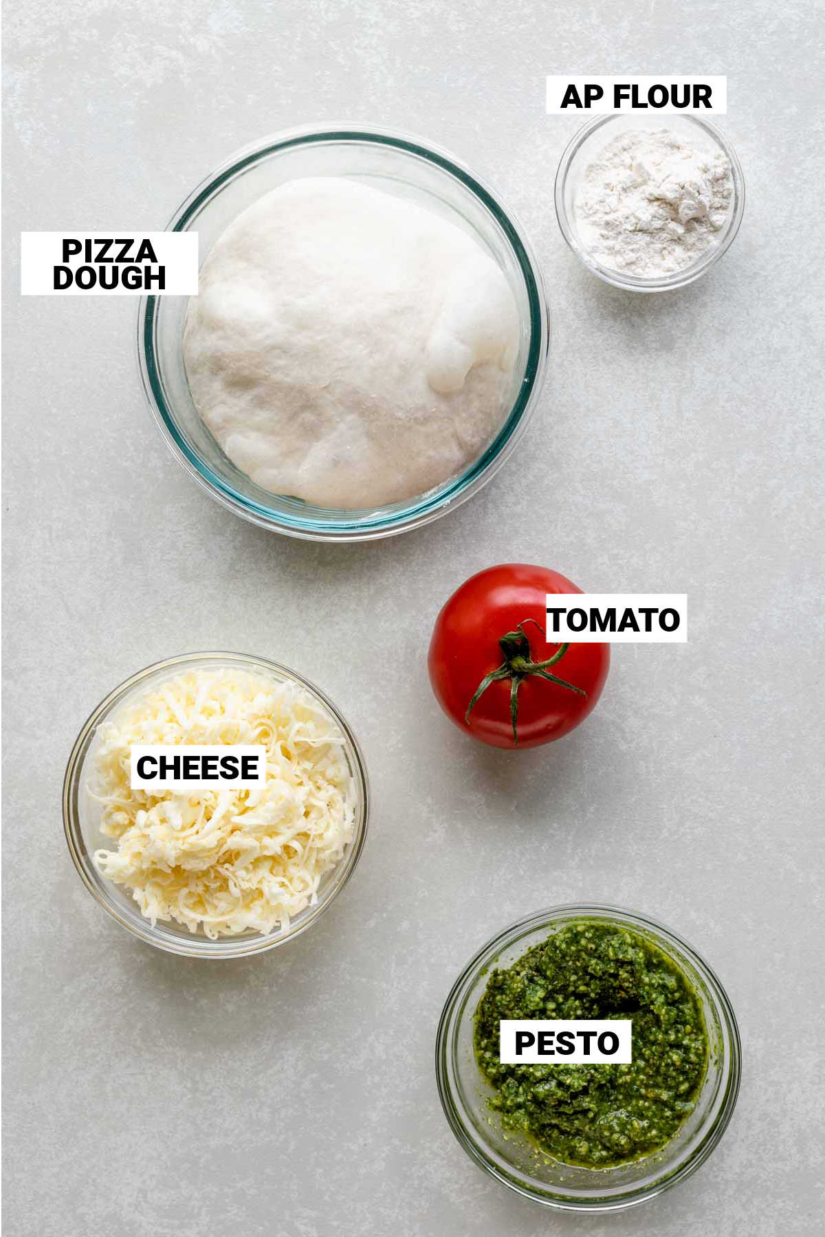the ingredients for the pizza on a white table
