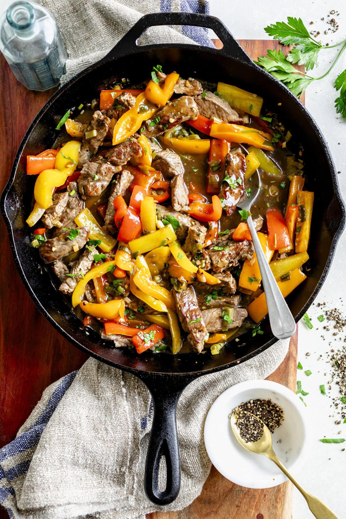overhead photo of pepper steak stir fry in cast iron skillet