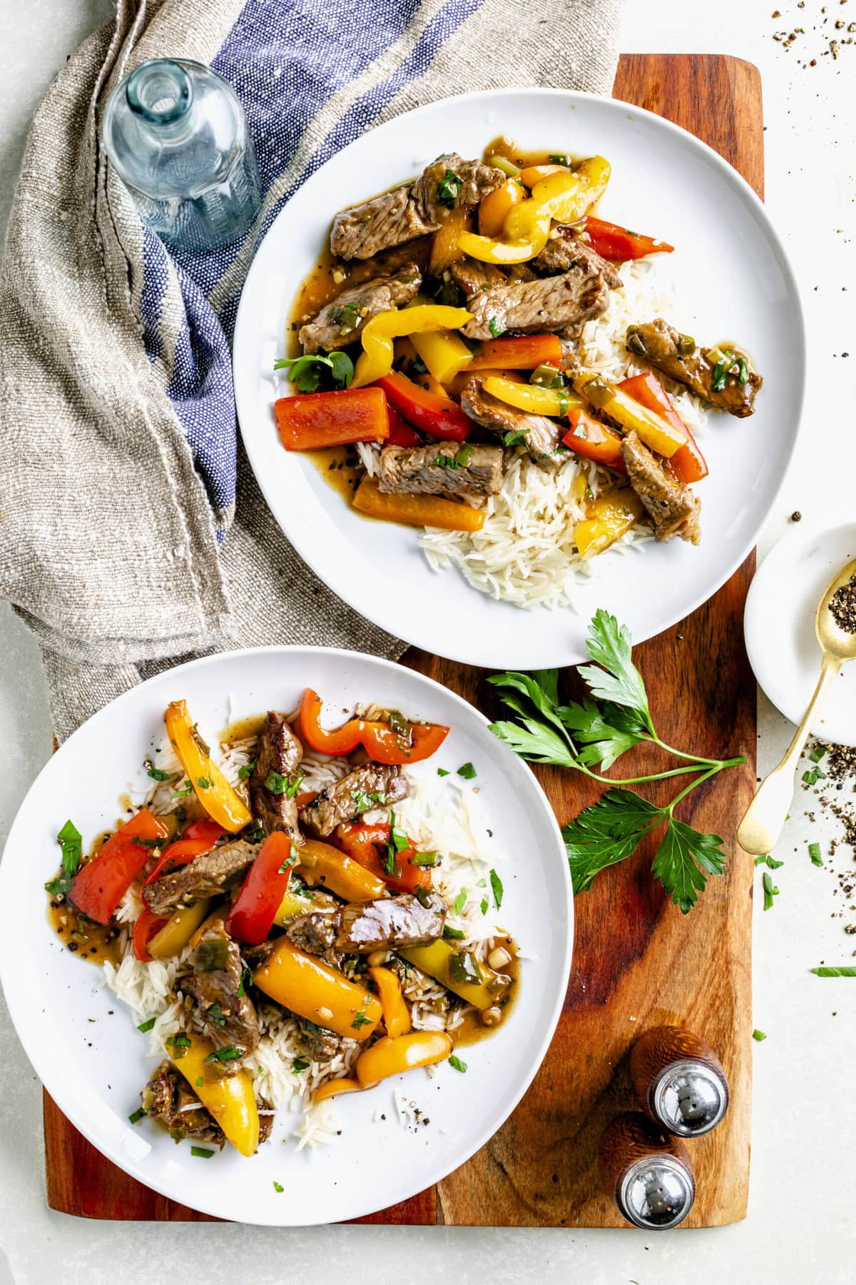 chinese pepper steak on circular white plates