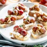 a platter of crostini from the side with a gray napkin