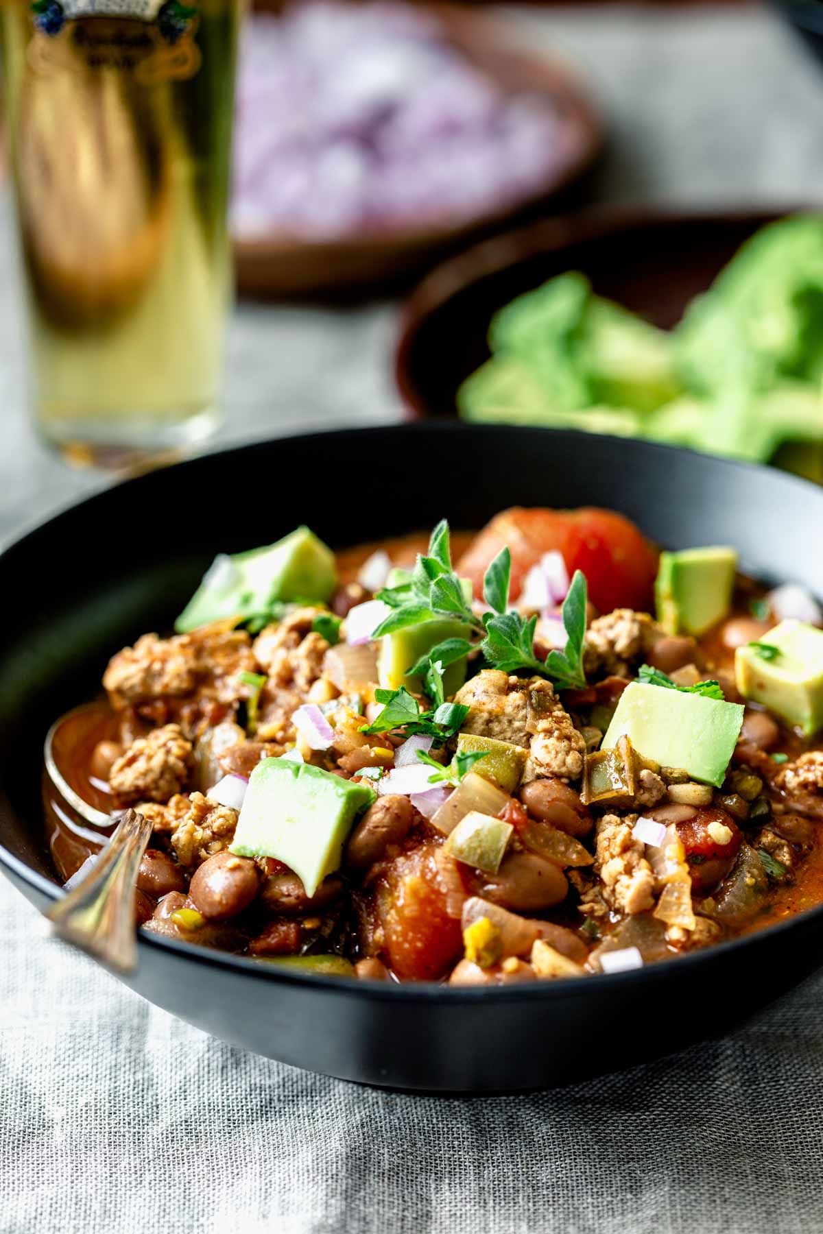 side view of turkey chili in a black bowl